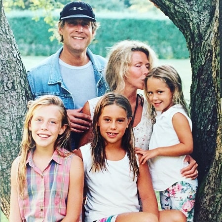 A picture of Caley and her sisters with their parents at their childhood.